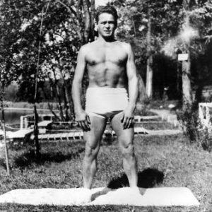 Joseph Pilates outside in nature with exercise mat
