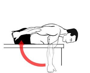 Image of male laying prone on bench extending arm