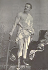 Am image of Eugen Sandow muscle posing with a sword in ancient Roman clothing.