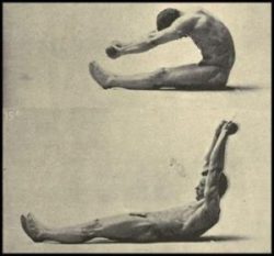 Eugen Sandow performing an abdominal exercise holding light dummbells.